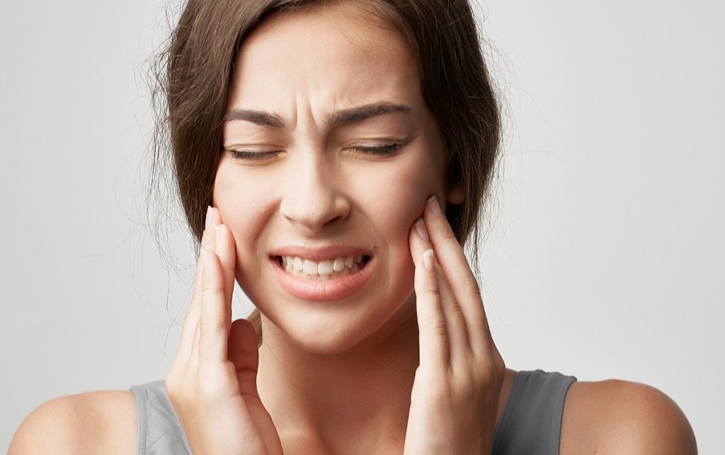 woman with tooth pain due to cavity